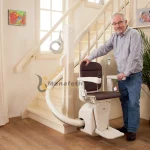An old person with special need using stair lift installed by Manafeth