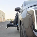 Kia Carnival Turny orbit side view in Dubai by Manafeth