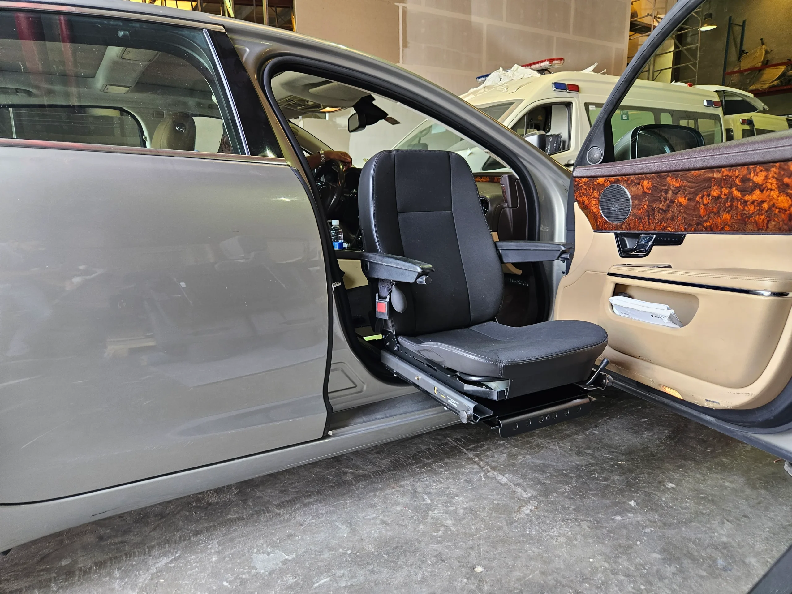 Black Turny Low Vehicle Swivel Seat installed in front passenger side for disabled access.