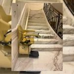 Stair lift for elderly standing at the start of stairs