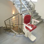 Stairlift for disabled people in white color with red seat